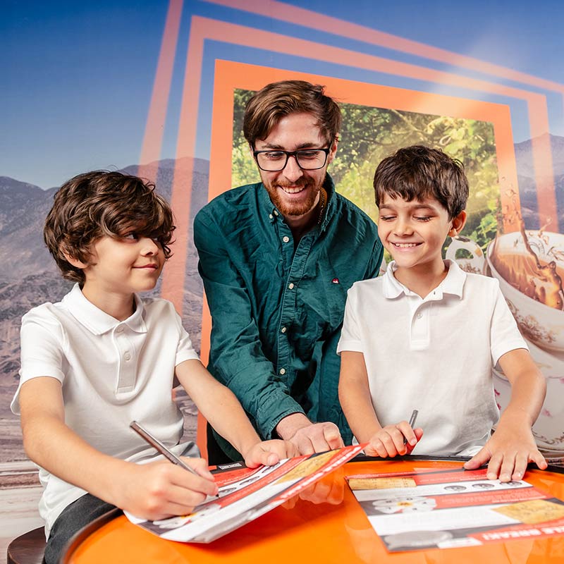 A teacher and two schoolboys in an escape room